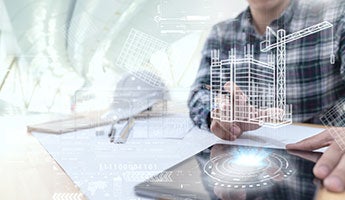 a man looking at a construction plan on a tablet