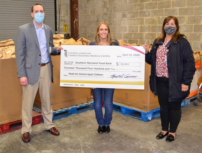 People holding a ceremonial check