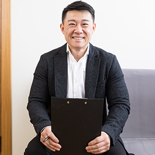 ASHE PDC Summit attendee type: Health Care Facility Management Professional | A man smiles at the camera and holds a clipboard