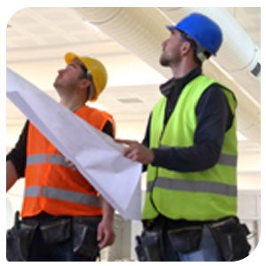 Facility managers with blueprints