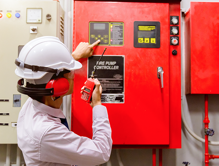 NFPA 99 technician examining fire unit