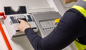 a hand adjusting the controls on a piece of equipment