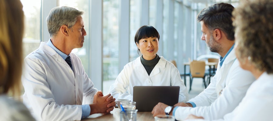 Docs sitting around a table
