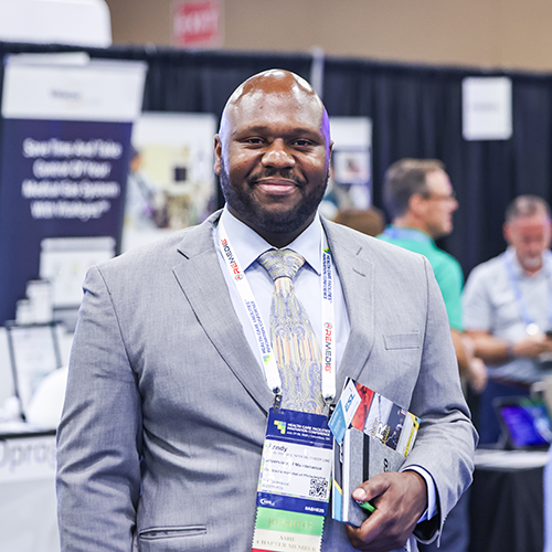 man standing and smiling in exhibit hall