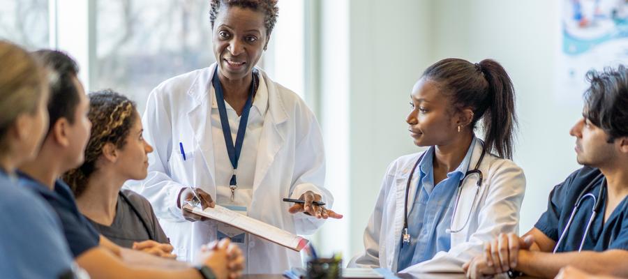 Nurses around a table taking direction